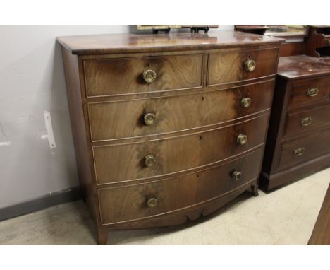 A Victorian bow fronted mahogany chest of drawers with two short and three long drawers and shaped apron to the base, height 