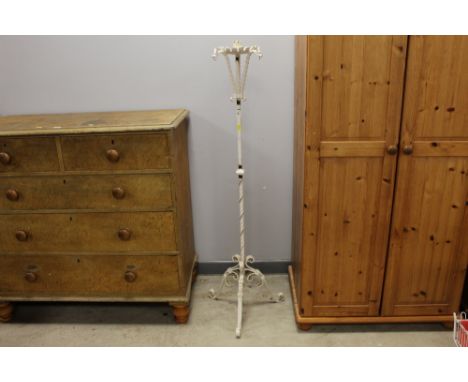 A Victorian wrought iron candle stand with three dragon heads and raised on a tripod base, overall height 143 cm