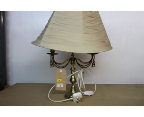 A candelabra style decorative table lamp with shade