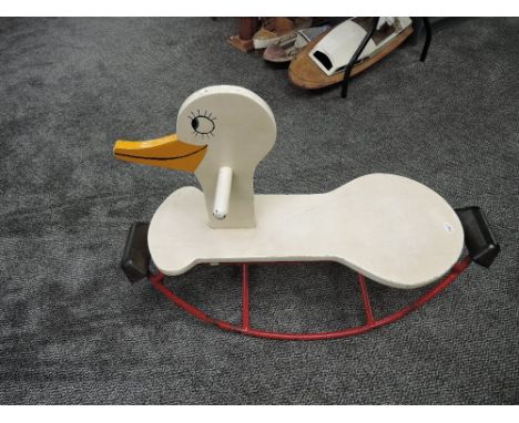 A vintage Child's Rocking Swan having wooden seat, head and handle with metal frame with protective rubber stops marked Dunlo