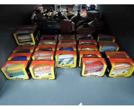 A shelf of 1983 Corgi die-cast Buses, Suntrekker, Routemaster and similar, all in yellow, red &amp; black window display boxe