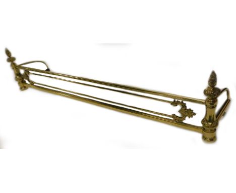 A brass and iron fender, in French style with floral finials, foliate scroll moulding, etc., 136cm W.
