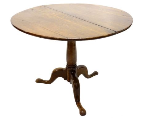 An early 19thC oak tilt top table, the circular top above a bird cage and a turned column on tripod base with pad feet, 90cm 