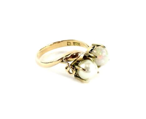 An opal and diamond dress ring, with single opal in four claw setting, and single cultured pearl in four claw setting, on twi