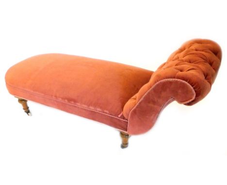 A Victorian ash day bed, upholstered in red fabric, on turned legs with ceramic castors.