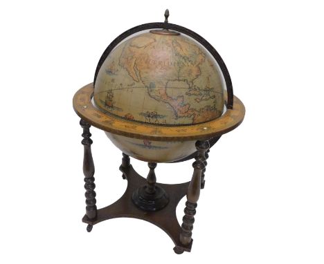 A vintage globe shaped cocktail cabinet, the lid enclosing a fitted interior on turned pine supports, with concave under tier