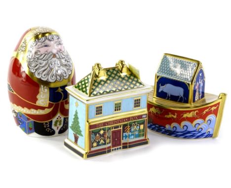 Three Royal Crown Derby Christmas ornaments, a small Noah's Ark toy, a Christmas box or tin and a Father Christmas paperweigh