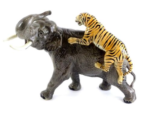 A Beswick ceramic model of an elephant, being attacked by a tiger, 30cm H.