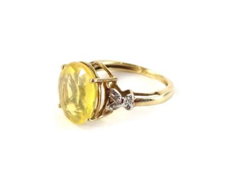 A 9ct gold dress ring, set with central oval cut yellow stone, and white stone set shoulders, in a cross design, ring size K,