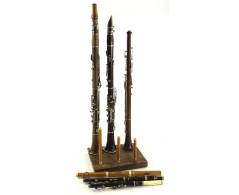 Two early 20thC rosewood clarinets, and another part clarinet etc., the largest 70cm L.