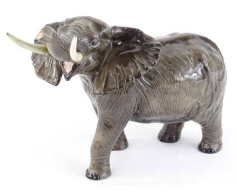 A Beswick pottery model of an elephant,  with trunk raised etc, 38cm L.