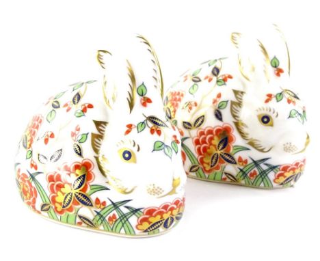 A pair of Royal Crown Derby Collectors Guild Meadow Rabbit paperweights, each with a gold button.