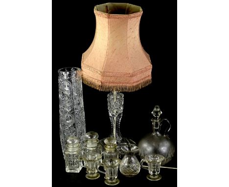 A cut glass table lamp with fabric shade, slender cut glass vase, claret jug and stopper, custard cups etc.