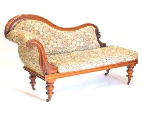 A Victorian mahogany chaise lounge, with show frame, padded back arm rest and squab cushion, on turned tapering legs with cer