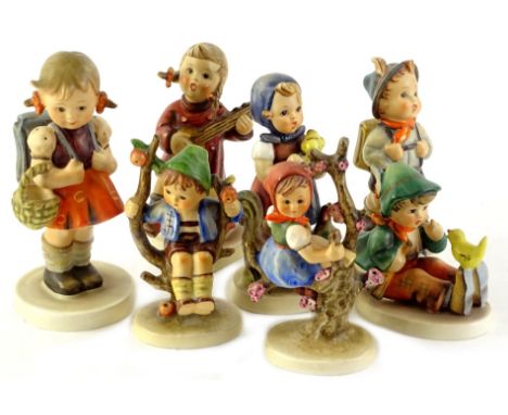 A collection of seven Goebel Hummel figures, to include girl with satchel and basket, a girl in a tree, etc.