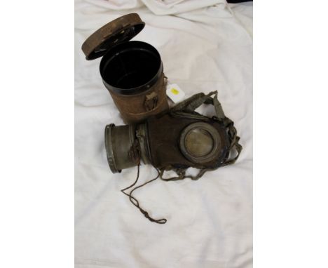 First World War Imperial German gas mask of leather construction, with canvas straps, in original tin carrying case, with int