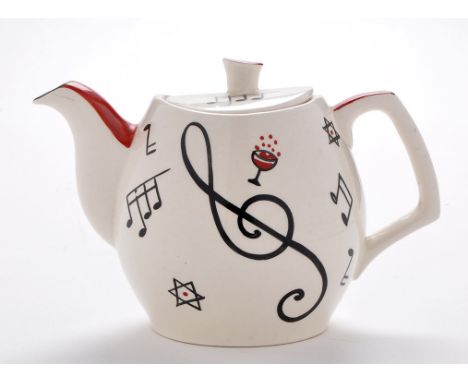 Gibsons: a teapot, decorated with musical notes, wine and stars, mark to base with painted registration W353, 14.5cms (15 3/4