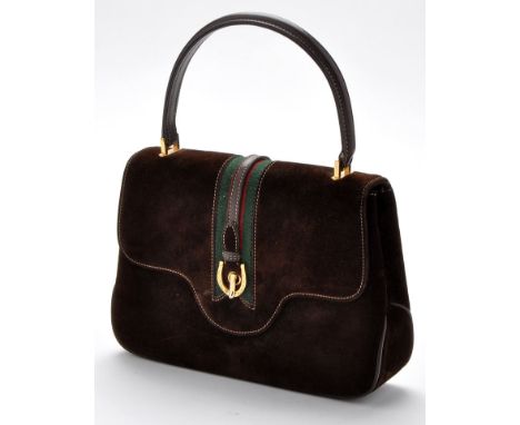 Gucci: a brown suede handbag, with horseshoe clasp and green/red stripe; together with bag cover and original box. 