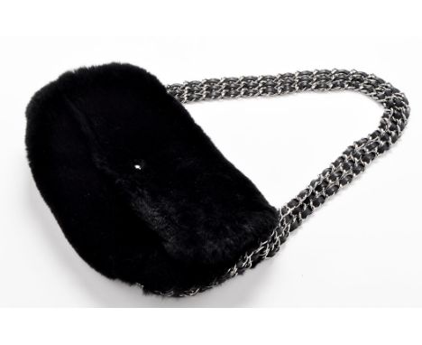 Chanel: A black rabbit fur handbag, with triple metal and leather chain linked strap, a white metal monogram clasp opening to