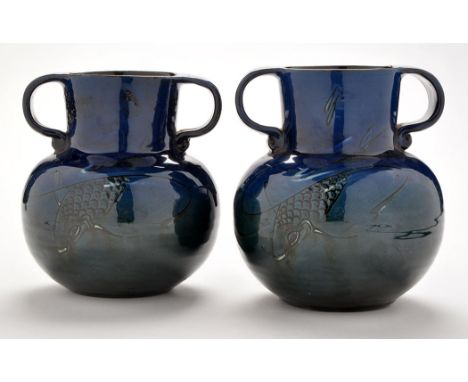 C. H. Brannam for Liberty & Co: a pair of Arts & Crafts twin-handled vases, with carp decoration on blue and green ground gla