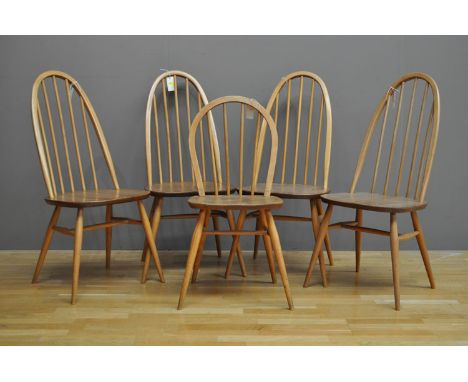 Ercol: four elm seated spindle back chairs; together with a smaller windsor type elm seated chair. (5)