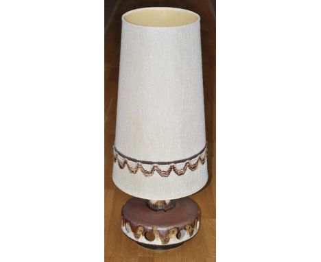 A 1970's  lamp of circular squat form, with metallic glazes; and woollen lamp shade of tapering cylindrical form, 27cms (10 1