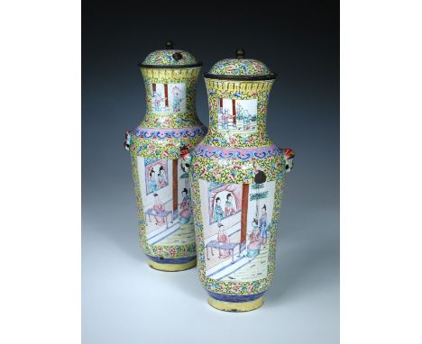 A pair of 19th century Canton enamel vases and covers, the figure reserves painted on yellow grounds of scrolling lotus, the 