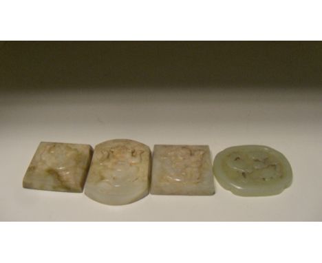 A grey green jade quatrefoil, possibly Ming together with three appliques, the first carved in relief on one side with a cran