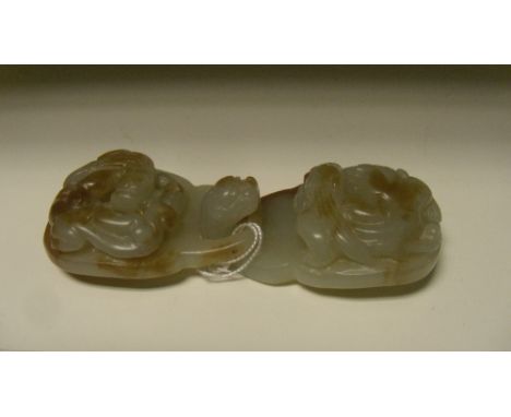A honey mottled pale grey jade belt buckle, each part carved in relief with heads, the qilin linking into the dragon's head h