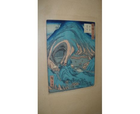 Hiroshige, a woodblock print depicting a temple below and viewed through a limestone arch, carvings of Bodhisattvas to one si