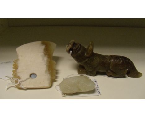 A nephrite jade sage, archaic axe head and a greenstone qilin, the first of pale grey stone, the man with a bat on his should