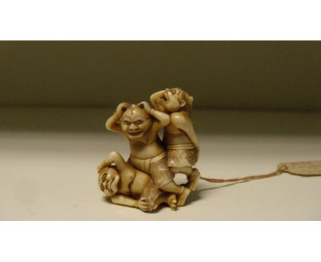 Ryoji', an ivory netsuke of three oni, each holding their heads and tumbling as if hit by beans in the Spring festival, signe