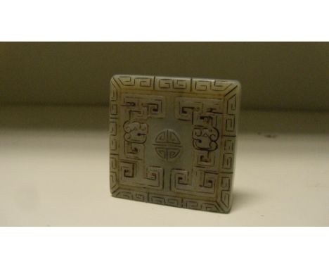 A pale grey jade rectangular pendant, possibly 18th century, carved on one side with chilong surrounded with shou and on the 
