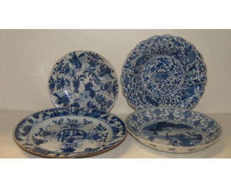 Four 18th century blue and white plates, one painted with fish on the lobed rim enclosing crab roundel, 21cm (8.25 in) diamet