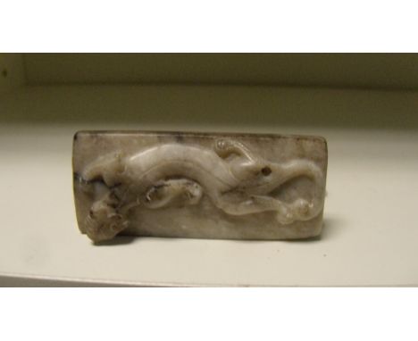 A grey jade rectangular pendant carved with archaic scrolls on one side and a qilin on the other, the suspension hole drilled