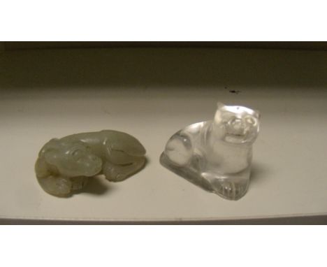 A jade qilin and a rock crystal recumbent carnivore, the clear flocculated stone of the first carved as a crouching beast wit