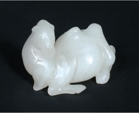 An 18th century white jade Bactrian camel carved as a resting animal with its head turned, 6cm (2.25 in) wide  