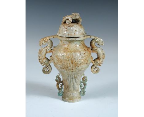 A 'Chicken Bone' jade vase and cover, the baluster shape carved with daodieh band between dragon handles, the reeded band abo