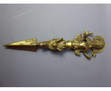 A Tibetan brass phurba with ganesh finial. H-33cm. 