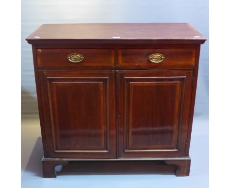 An Edwardian mahogany side cabinet with two drawers above two cupboard doors raised on carved bracket feet, H:94cm W;99cm D:4