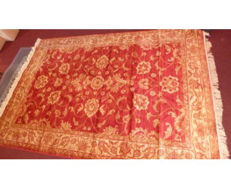 A Ziegler style carpet with floral decoration on a red ground contained by borders. 230cm X 160cm