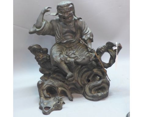 A 19th Century Chinese bronze figural study of a scholar sitting on a rocky out  crop, H:33cm W:32cm