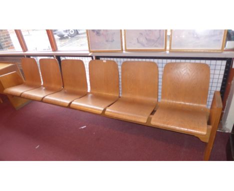 A 20th Century oak six seater bench raised on side panels joined by stretcher. H-84cm W-300cm D-47cm