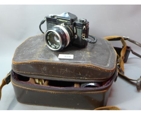A vintage Nikon Nikkormat camera with extra lenses  an in original leather case. 