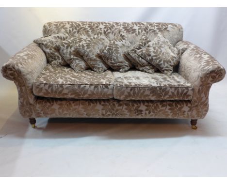 20th Century two seater sofa and matching pouffe on caster feet having velvet leaf design 