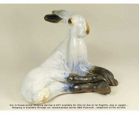 MICHELLE COWMEADOW. A large glazed model of a hare. Height 29cm. Length 38cm.