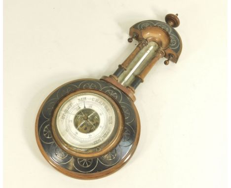 BAROMETER. An aneroid barometer/thermometer in part ebonised case. Height 38cm. (Glass cracked).