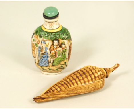 SNUFF BOTTLES. A moulded ceramic snuff bottle &amp; a resin corn cob snuff bottle.