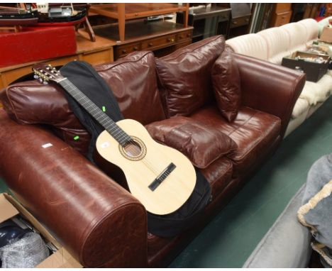 A brown two seater sofa