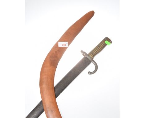 An Aboriginal boomerang and a WW1 military bayonet and scabbard (possibly Belgian) (2)